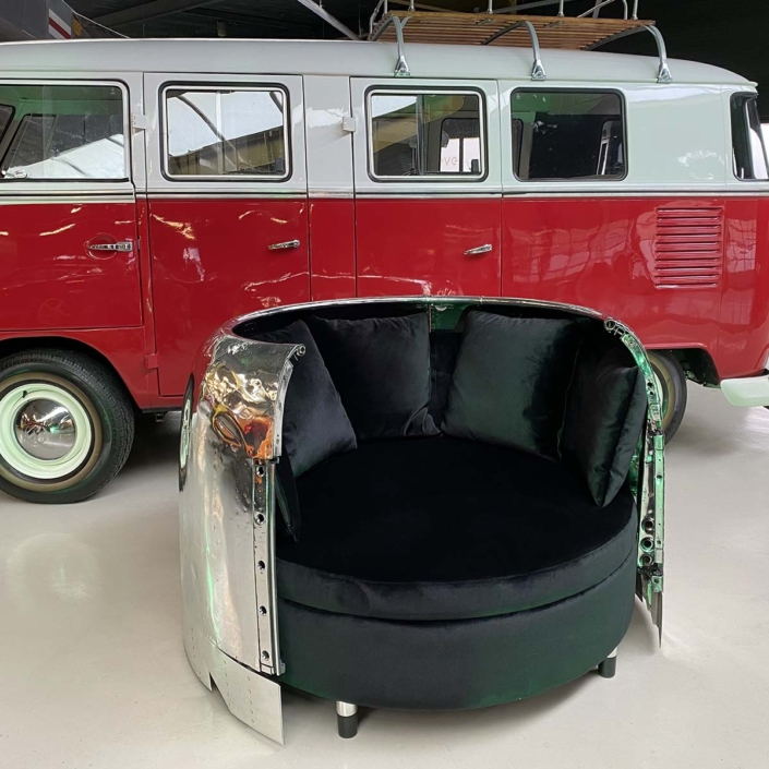 Douglas C-47 Dakota engine cowling love seat in front of a red Volkswagen Transporter T1 van.