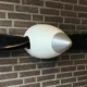 Side view of the spinner of a two-bladed McCauley propeller that is available as a decorative wall hanger.